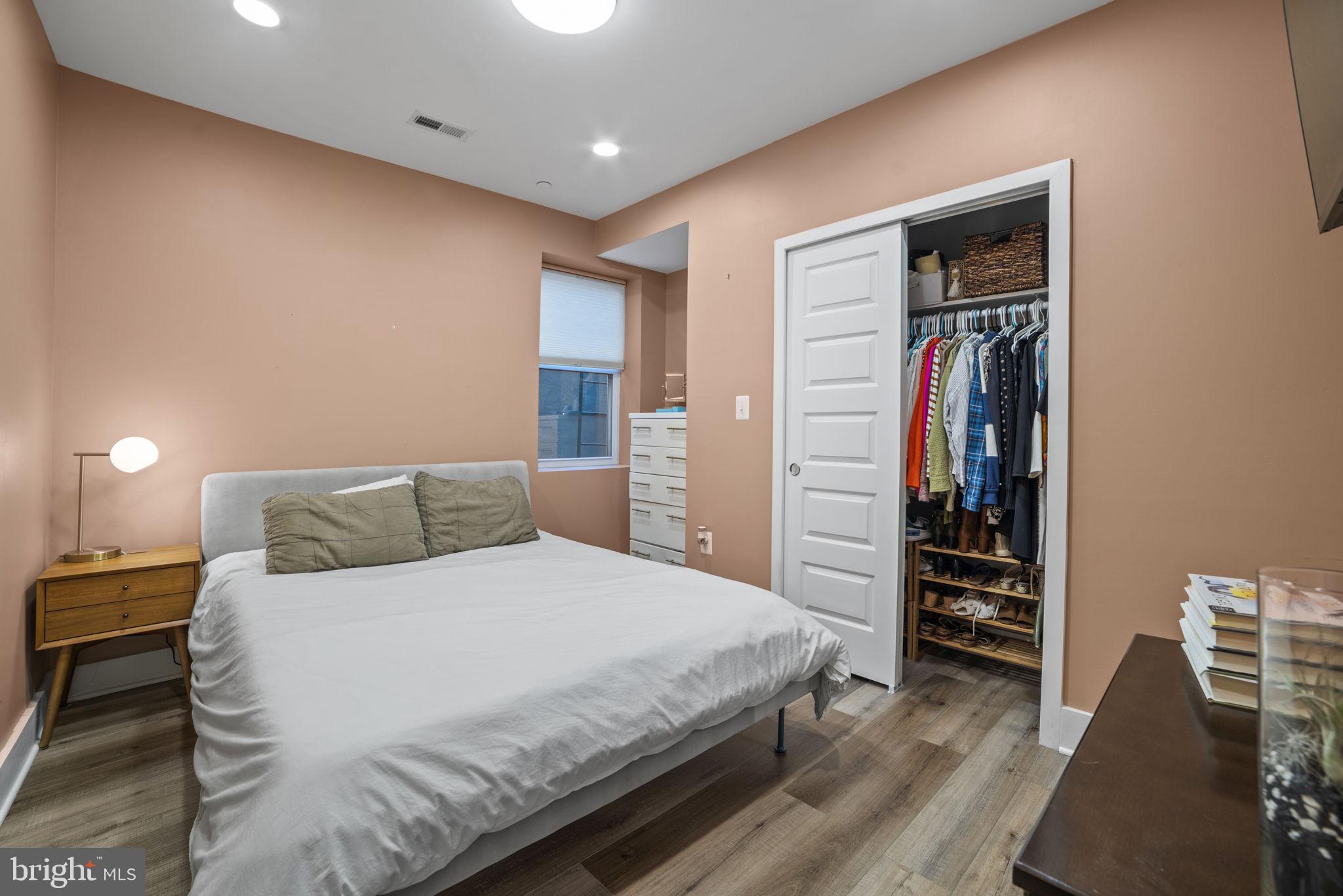 1838 Providence Street Northeast, Unit 2 Washington, DC 20002 - Photo 9 of 17 a bedroom with a bed and a walk in closet