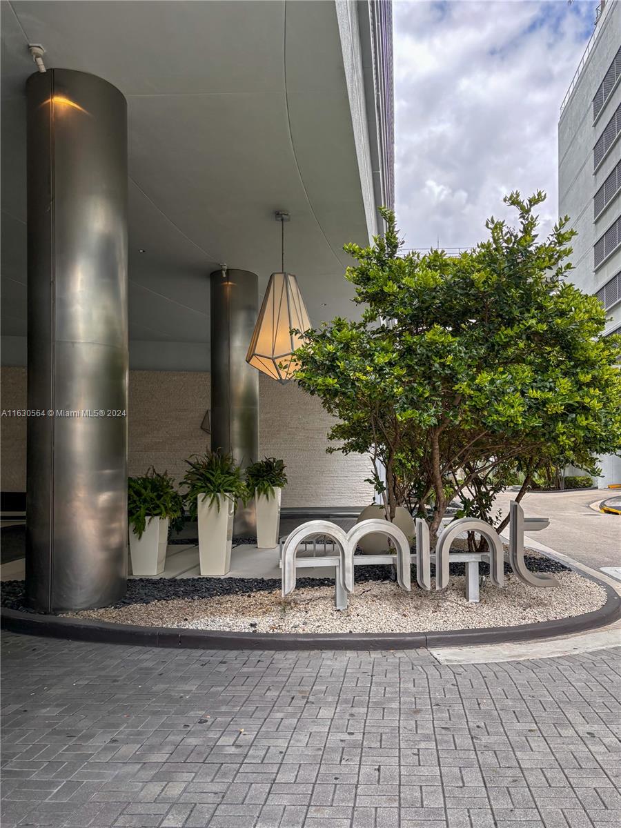 92 Southwest 3rd Street, Unit 4407 Miami, FL 33130 - Photo 20 of 21 a view of a house with a patio and a yard