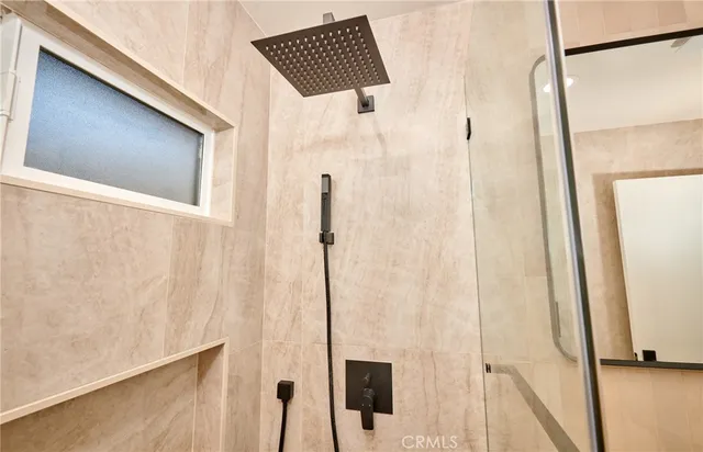 a bathroom with a shower and a window