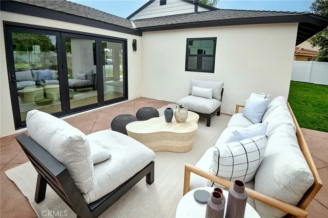a living room with furniture and a floor to ceiling window