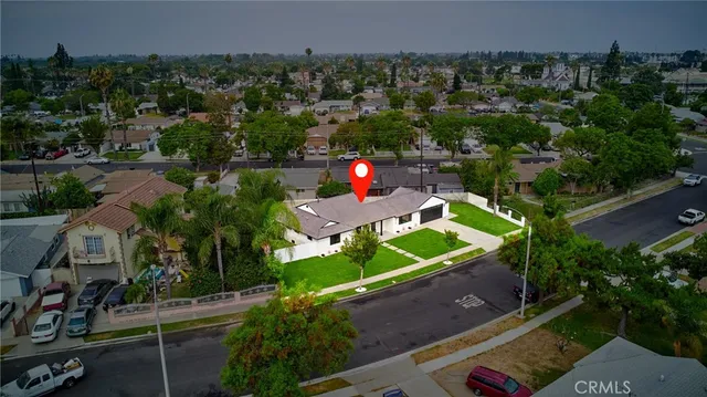 an aerial view of a house with a yard and lake view