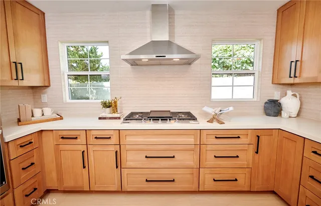 a kitchen with granite countertop a sink stainless steel appliances and a window