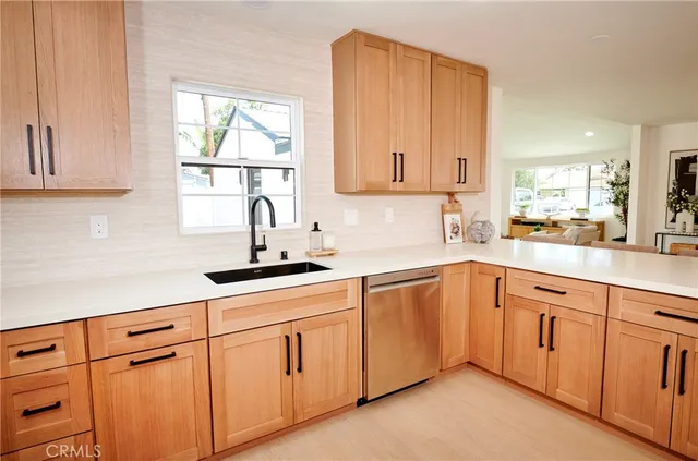 a kitchen with white cabinets white appliances and sink