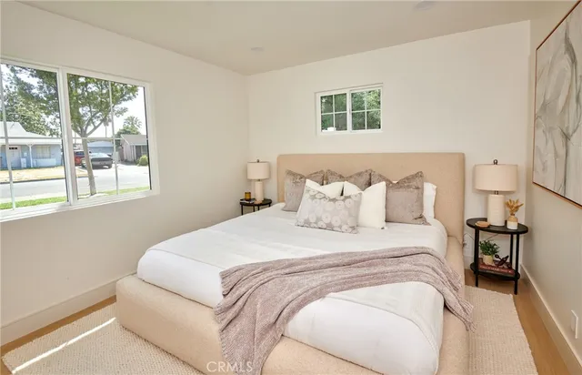 a bedroom with a bed and a large window