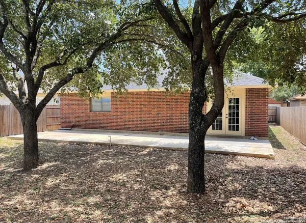 a sign board with tree in the background