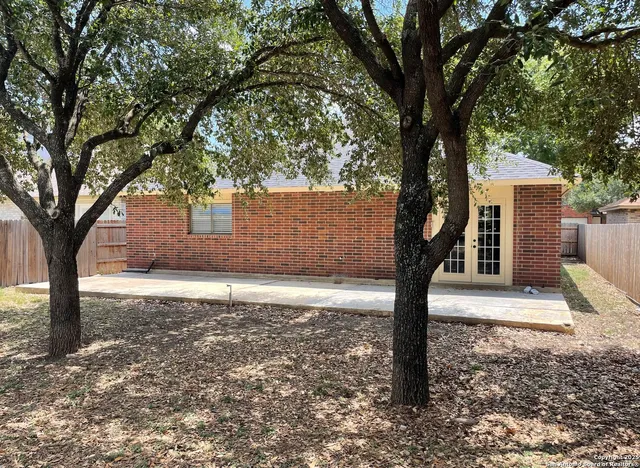 a sign board with tree in the background