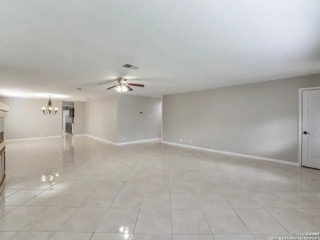 a view of a livingroom with a ceiling fan and window