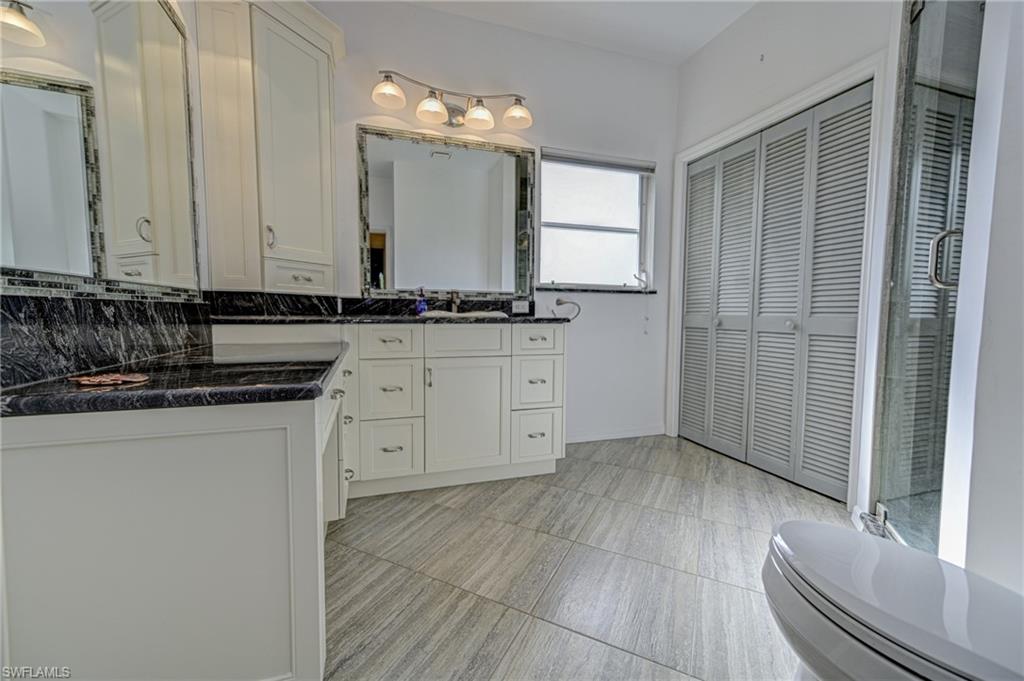 3858 Riviera Circle Bonita Springs, FL 34134 - Photo 12 of 34 a view of a kitchen with granite countertop a sink and dishwasher with wooden floor