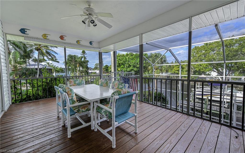 3858 Riviera Circle Bonita Springs, FL 34134 - Photo 14 of 34 a view of a patio with a table chairs and a table