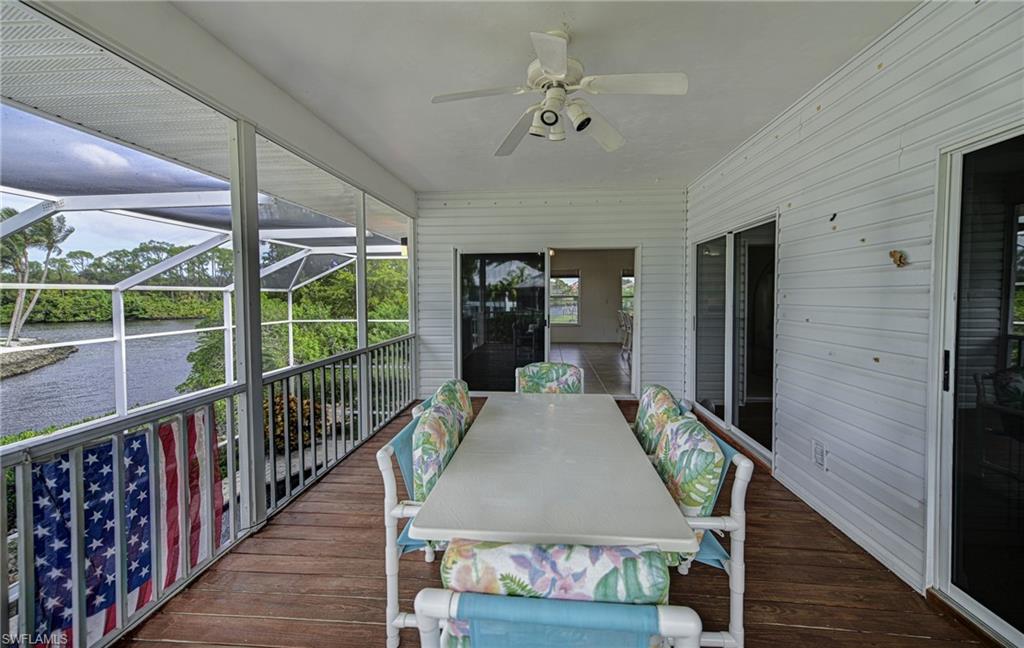 3858 Riviera Circle Bonita Springs, FL 34134 - Photo 16 of 34 a view of a balcony dining room and hall with wooden floor