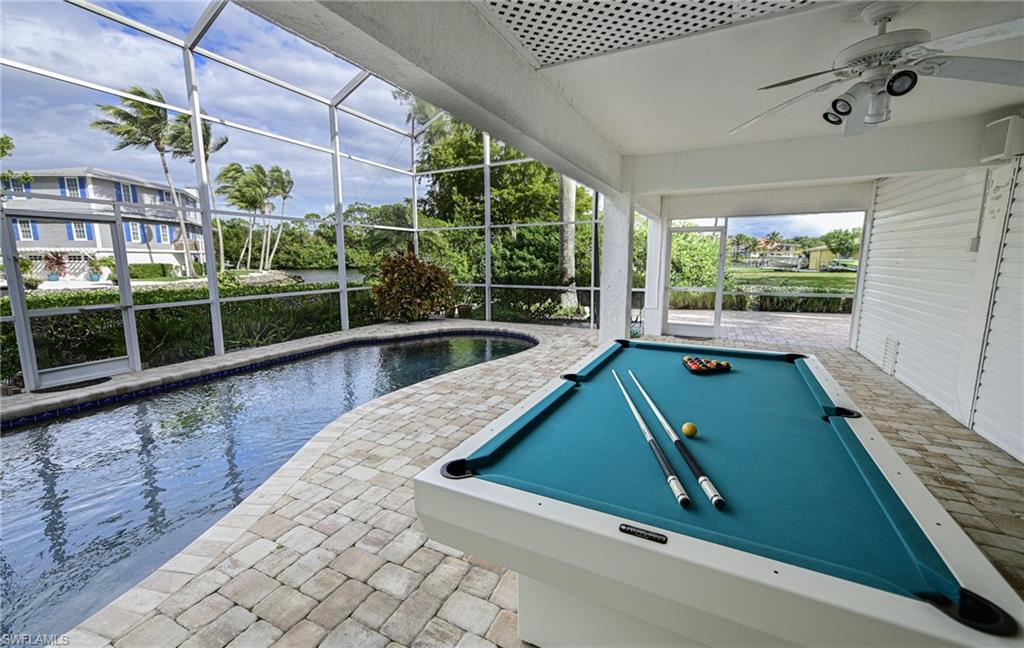 3858 Riviera Circle Bonita Springs, FL 34134 - Photo 17 of 34 a room with pool table and windows