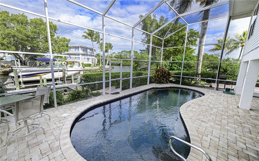 3858 Riviera Circle Bonita Springs, FL 34134 - Photo 18 of 34 a view of a swimming pool with a patio