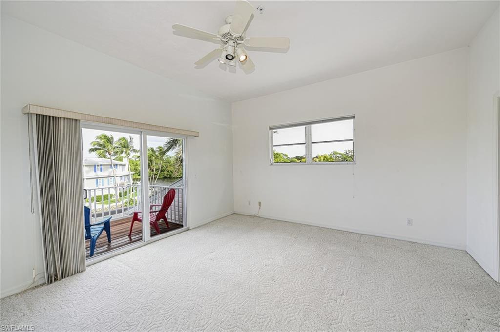 3858 Riviera Circle Bonita Springs, FL 34134 - Photo 19 of 34 an empty room with windows and ceiling fan