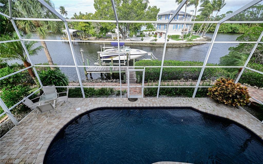 3858 Riviera Circle Bonita Springs, FL 34134 - Photo 23 of 34 a view of a chair and table in the patio