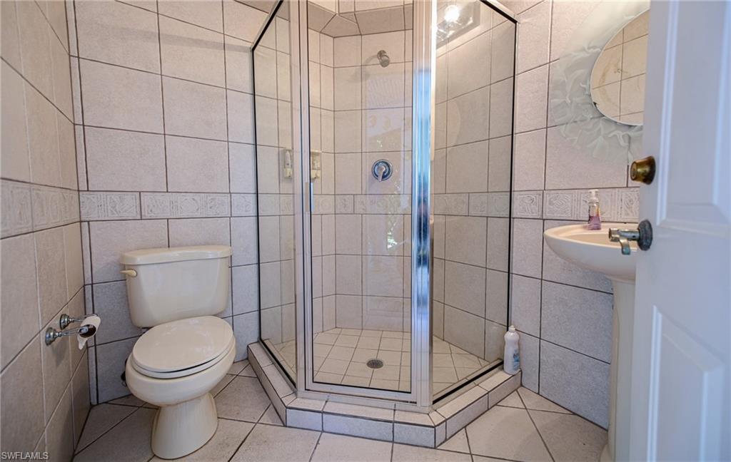 3858 Riviera Circle Bonita Springs, FL 34134 - Photo 26 of 34 a bathroom with a toilet and a shower