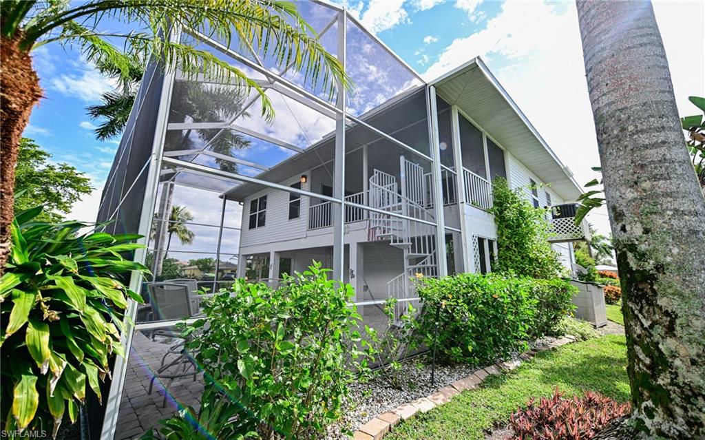 3858 Riviera Circle Bonita Springs, FL 34134 - Photo 32 of 34 a view of a house with a garden