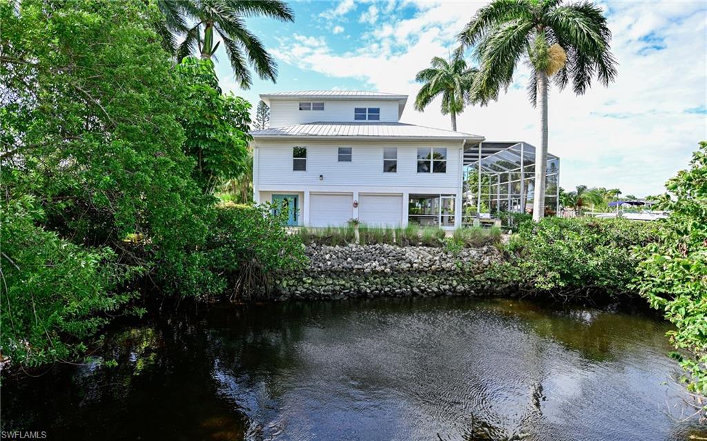 3858 Riviera Circle Bonita Springs, FL 34134 - Photo 34 of 34 a view of a lake with a building in the background