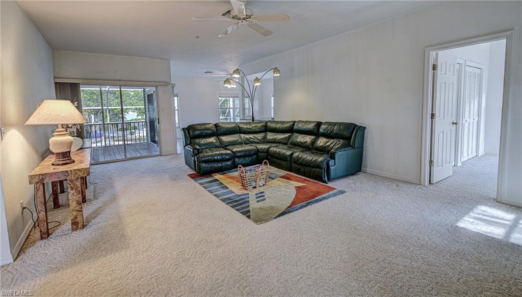 3858 Riviera Circle Bonita Springs, FL 34134 - Photo 5 of 34 a living room with furniture and a lamp