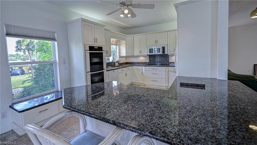 3858 Riviera Circle Bonita Springs, FL 34134 - Photo 6 of 34 a kitchen with large windows