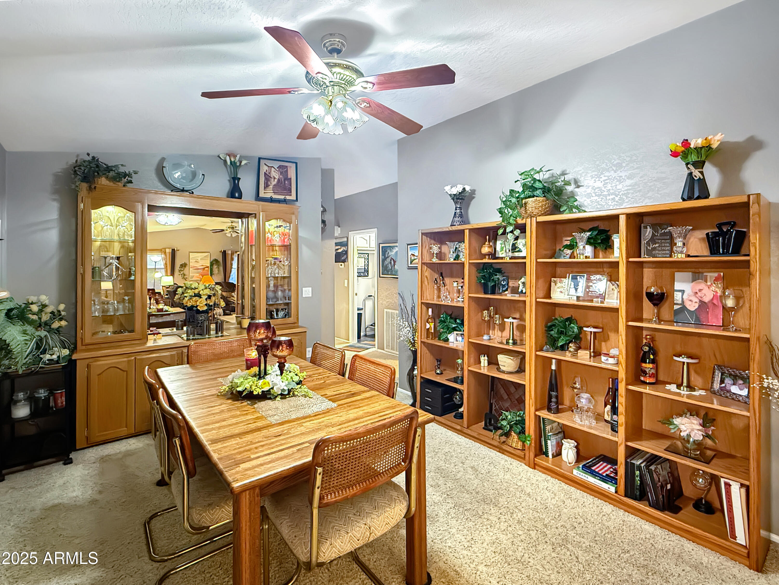3700 South Tomahawk Road, Unit 102 Apache Junction, AZ 85119 - Photo 11 of 25 a view of a dining room with furniture and a book shelf
