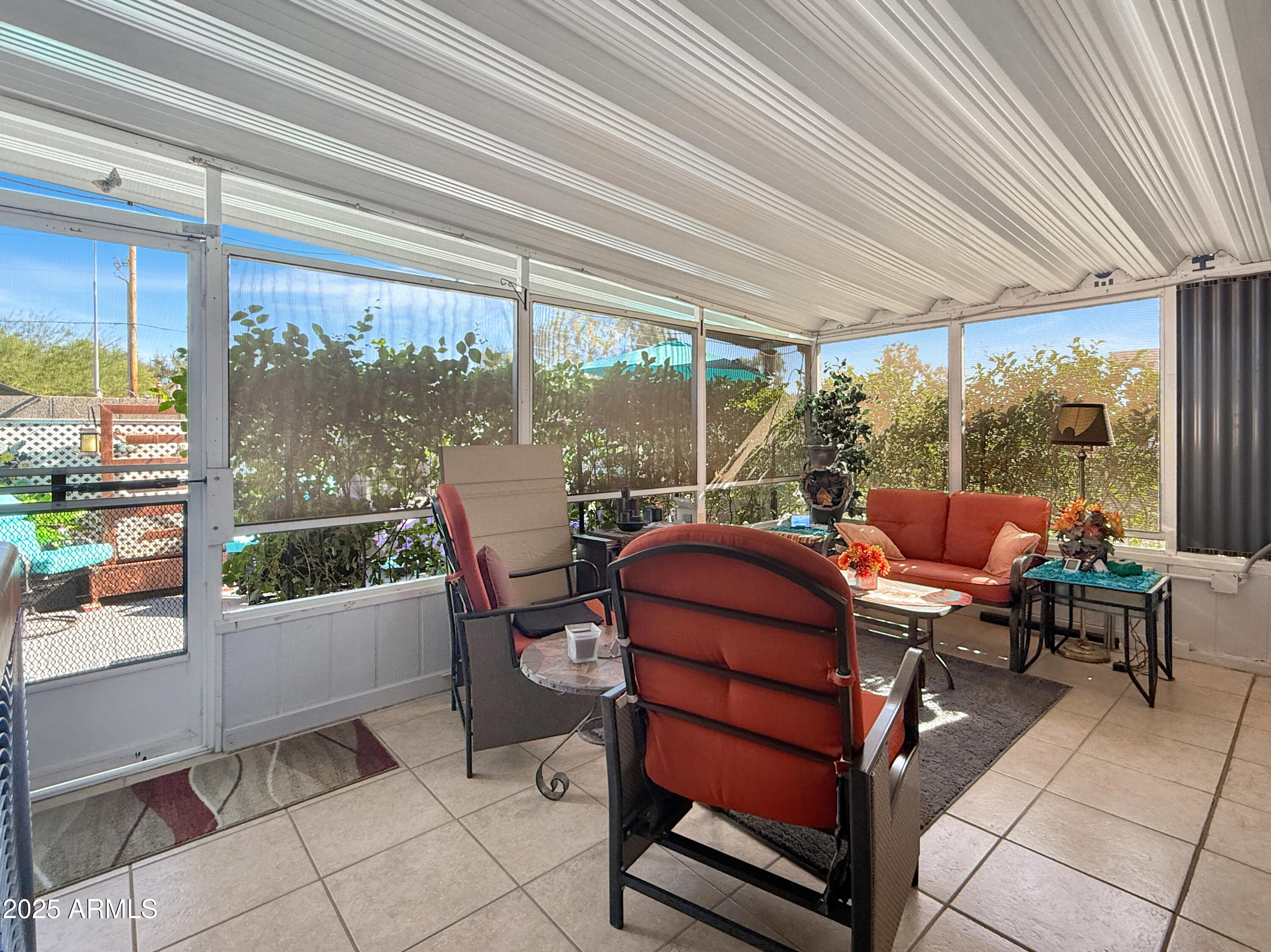 3700 South Tomahawk Road, Unit 102 Apache Junction, AZ 85119 - Photo 20 of 25 a living room with patio furniture and garden view