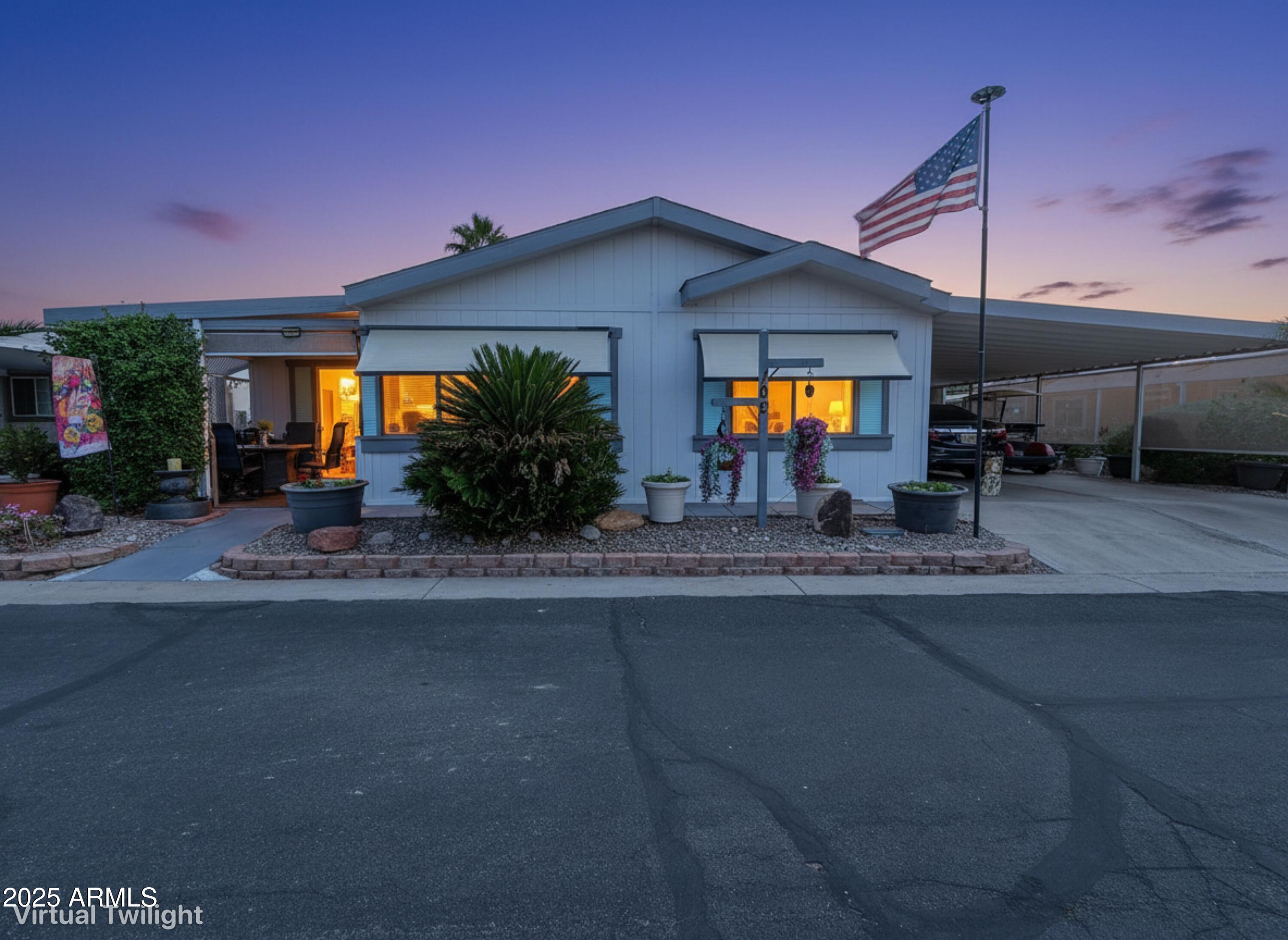 3700 South Tomahawk Road, Unit 102 Apache Junction, AZ 85119 - Photo 24 of 25 a view of a house with a porch and a car parked