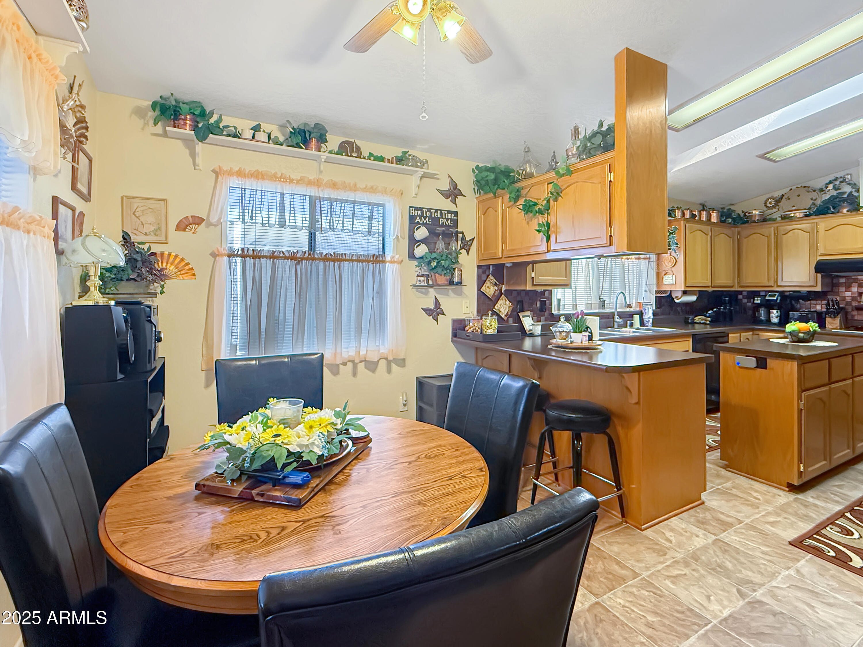 3700 South Tomahawk Road, Unit 102 Apache Junction, AZ 85119 - Photo 5 of 25 a dining room filled with furniture and a chandelier