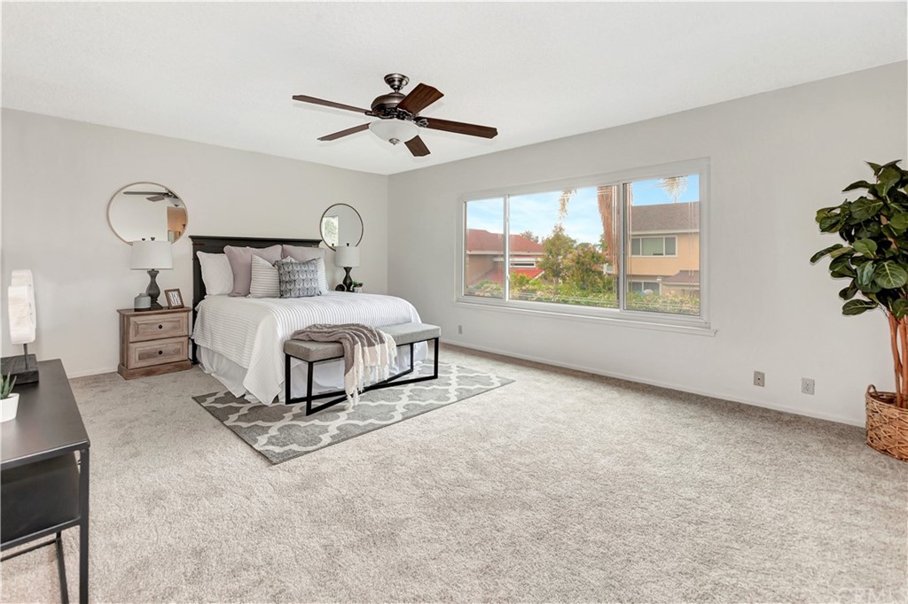 1645 Sandalwood Drive Brea, CA 92821 - Photo 9 of 16 a spacious bedroom with a bed a ceiling fan and a large window