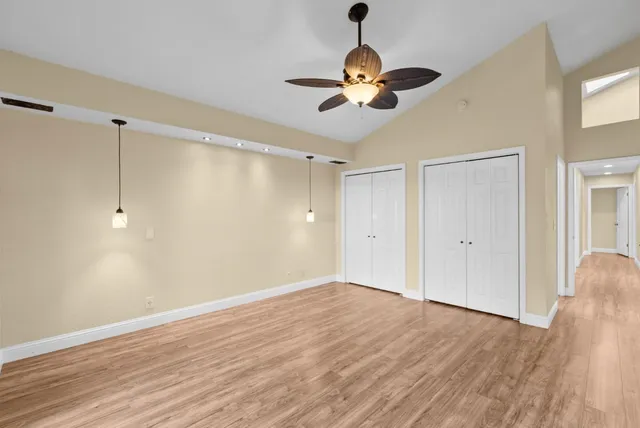 a view of empty room with wooden floor