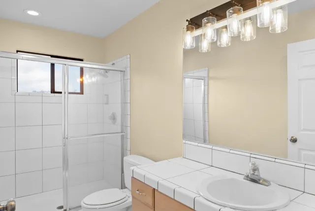 a bathroom with a sink toilet and shower