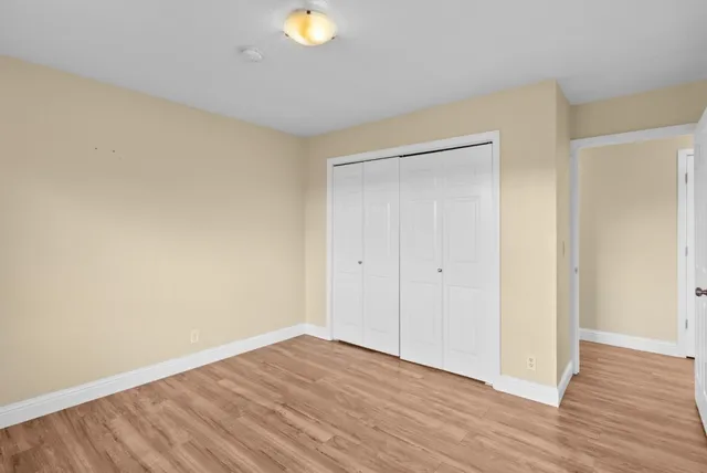 a view of an empty room and wooden floor