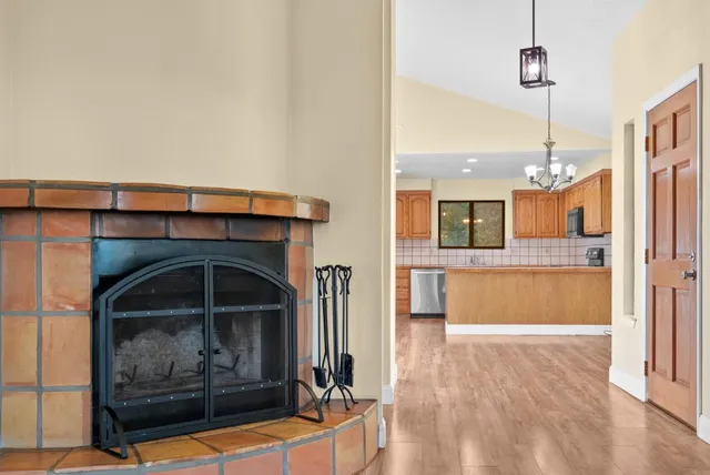 a kitchen with a fireplace and chandelier