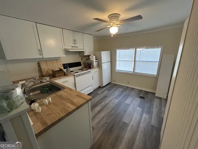 a kitchen with a sink appliances and cabinets