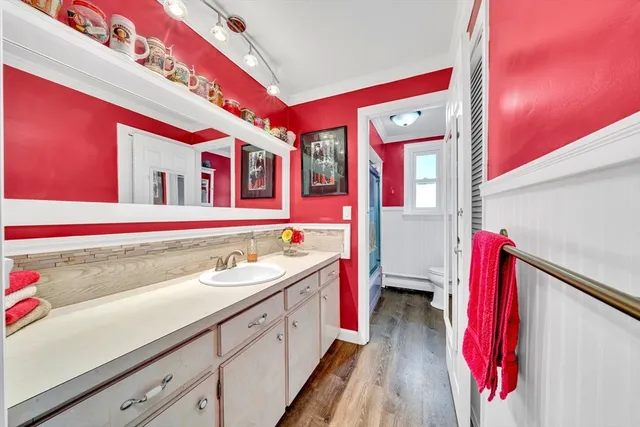 a bathroom with a sink vanity mirror and toilet