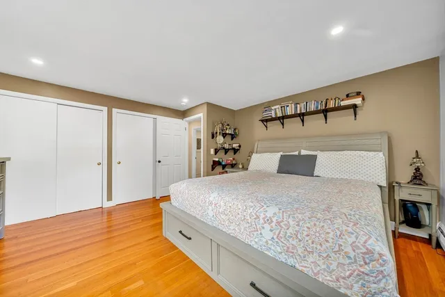 a bedroom with a bed and a potted plant