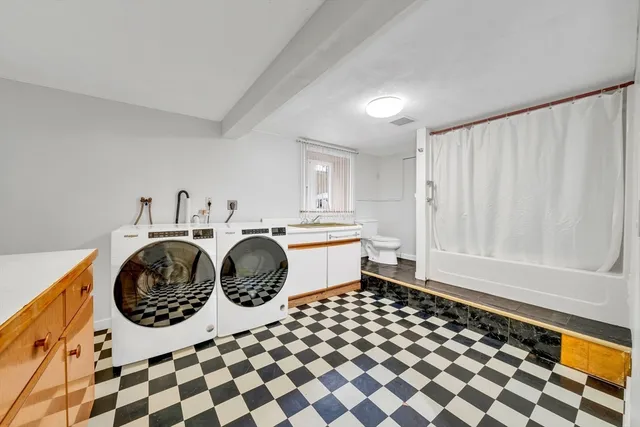 a view of a house with backyard and a tree