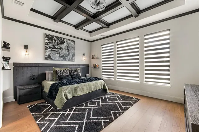 a bed sitting in a bedroom next to a window