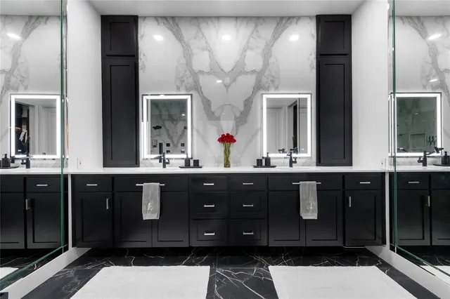 a bathroom with a double vanity sink and a mirror