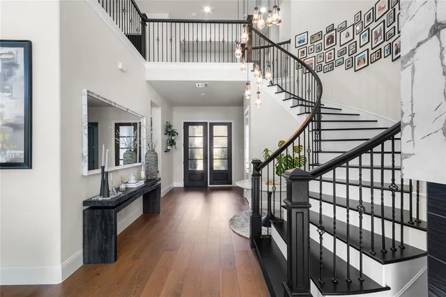 a view of entryway and hall with wooden floor