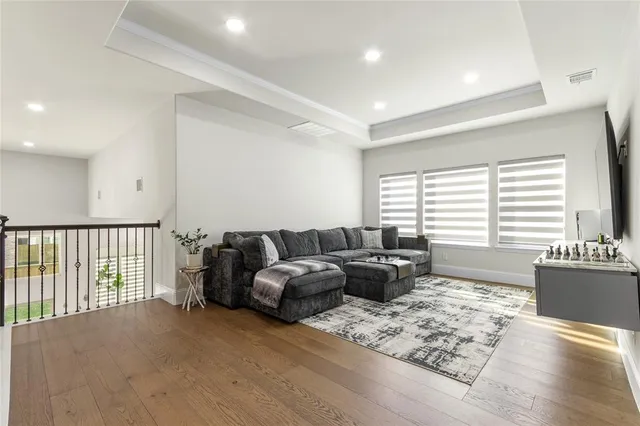 a living room with furniture window and wooden floor