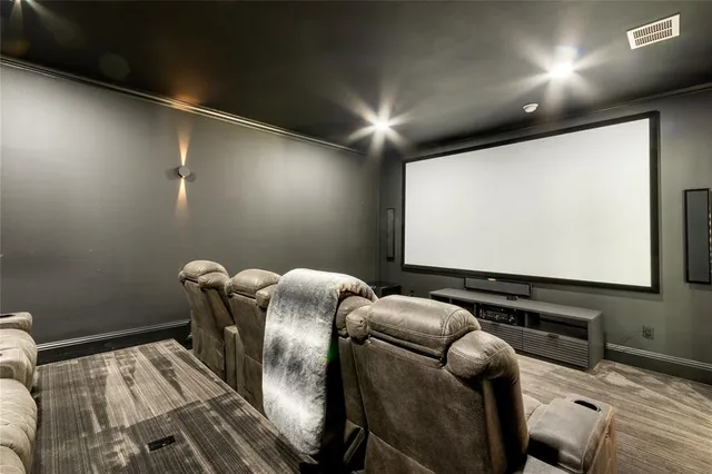 a room with furniture projector and screen