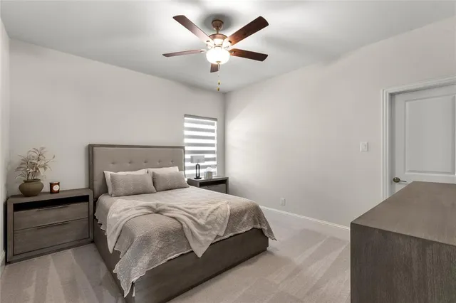 a bedroom with a bed and a ceiling fan