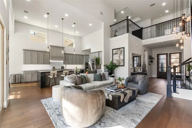 a living room with furniture kitchen and a chandelier