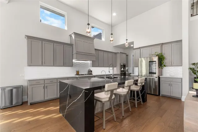 a kitchen with cabinets and chairs