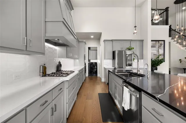 a large kitchen with stainless steel appliances granite countertop a lot of counter space