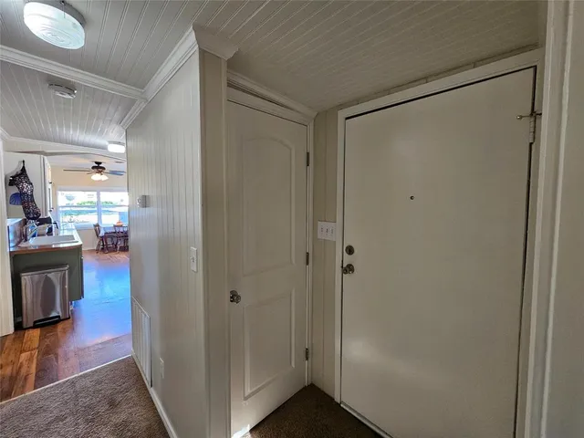 a view of a hallway with wooden floor