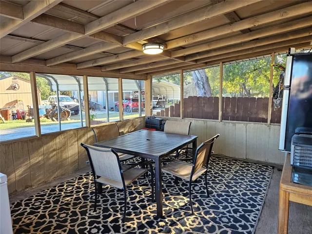 a view of a dining room with furniture large windows and wooden floor