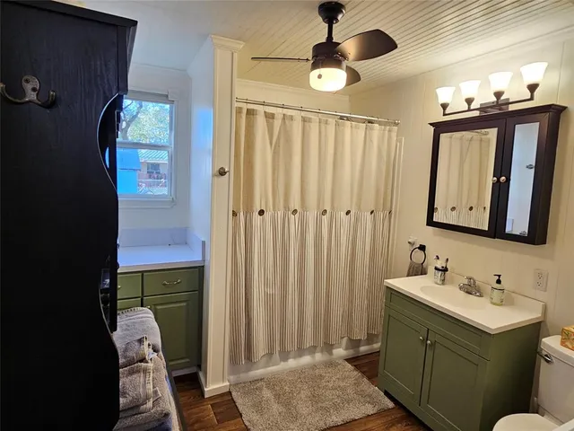 a bathroom with a sink vanity and mirror