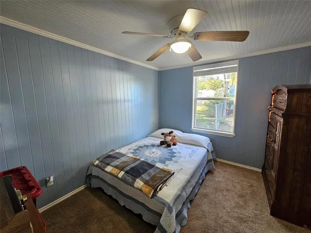 a bed sitting in a room next to a window