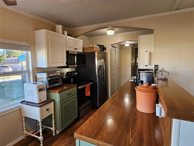 a kitchen with a sink appliances and cabinets